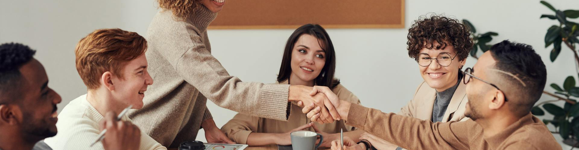 Cybersecurity team finalising an agreement and celebrating successful completion of a vCISO‑led security strategy meeting.