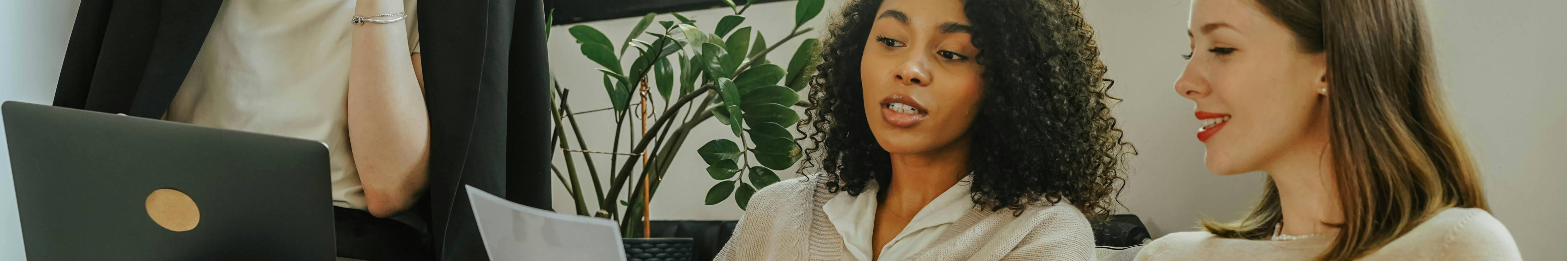 Team collaborating on cybersecurity planning and reviewing security documentation during a vCISO‑led strategy session.