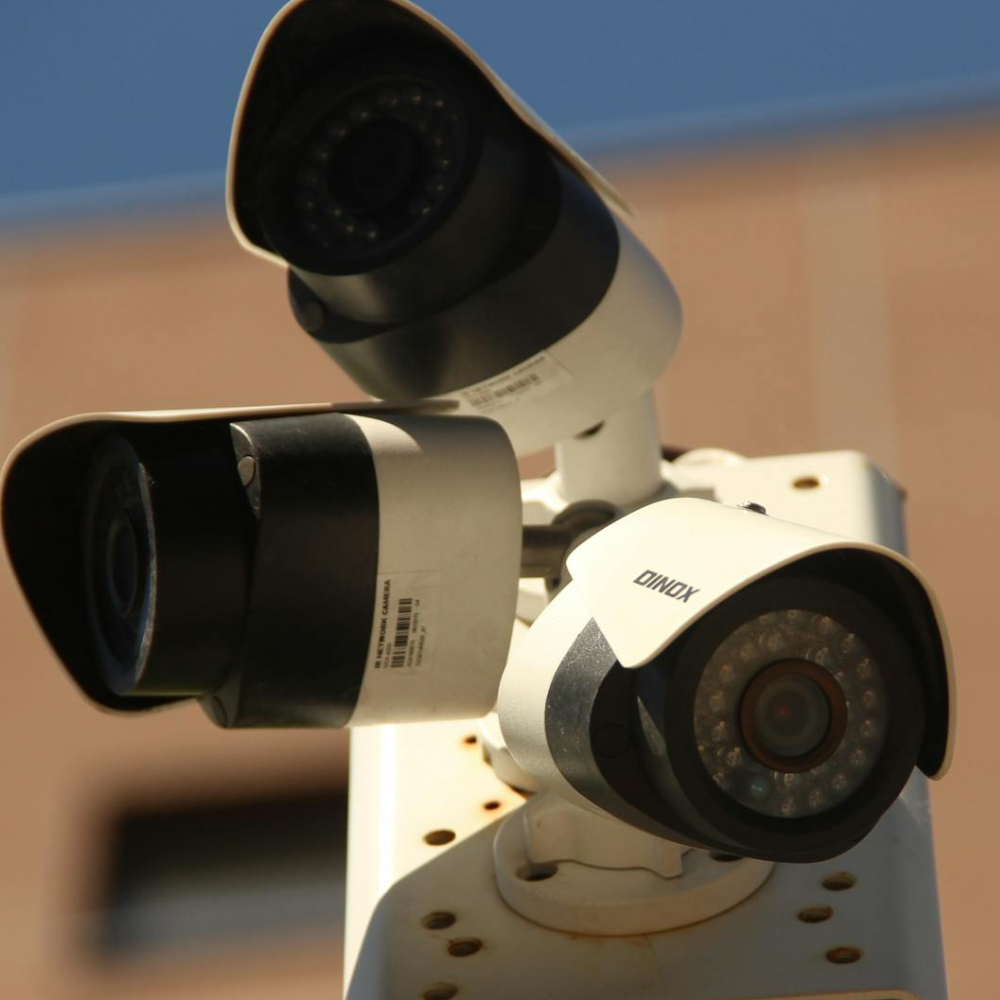 Physical security cameras that are controlled by networked systems which can be exploited