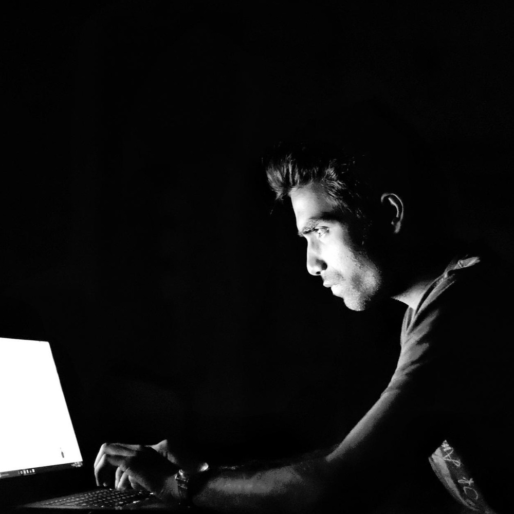 Man performing a penetration test on a network in darkness